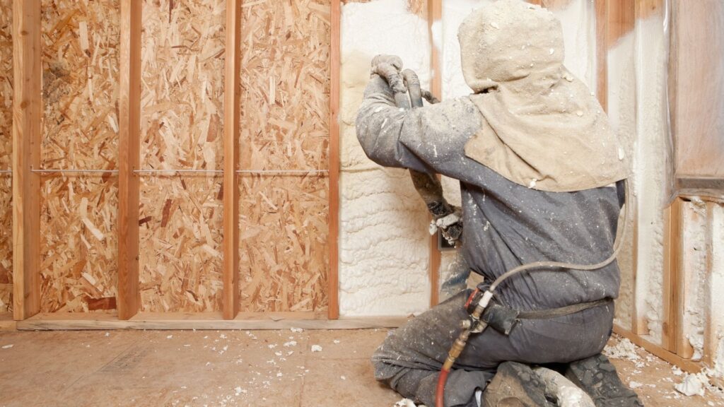 Person spraying spray foam insulation