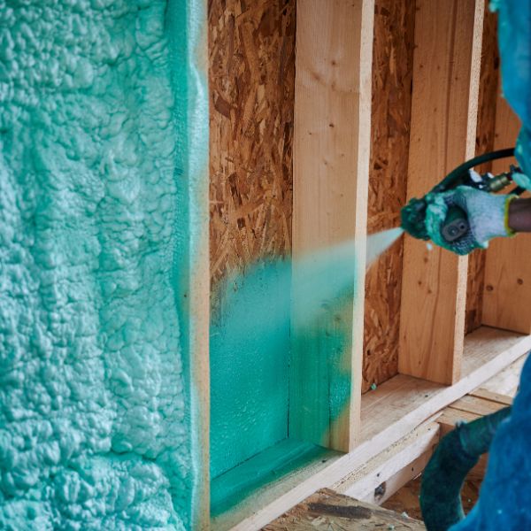 Man spraying foam insulation