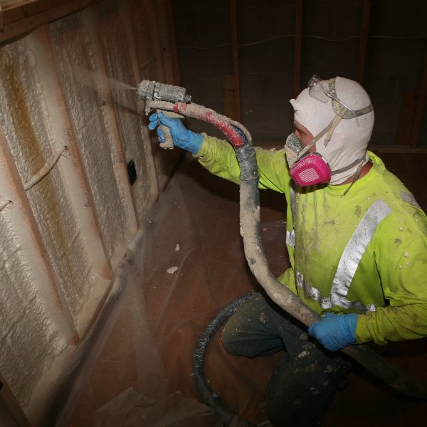 Man spraying foam insulation