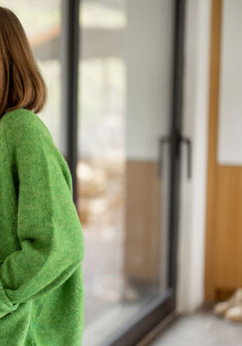 woman adjusting a thermostat